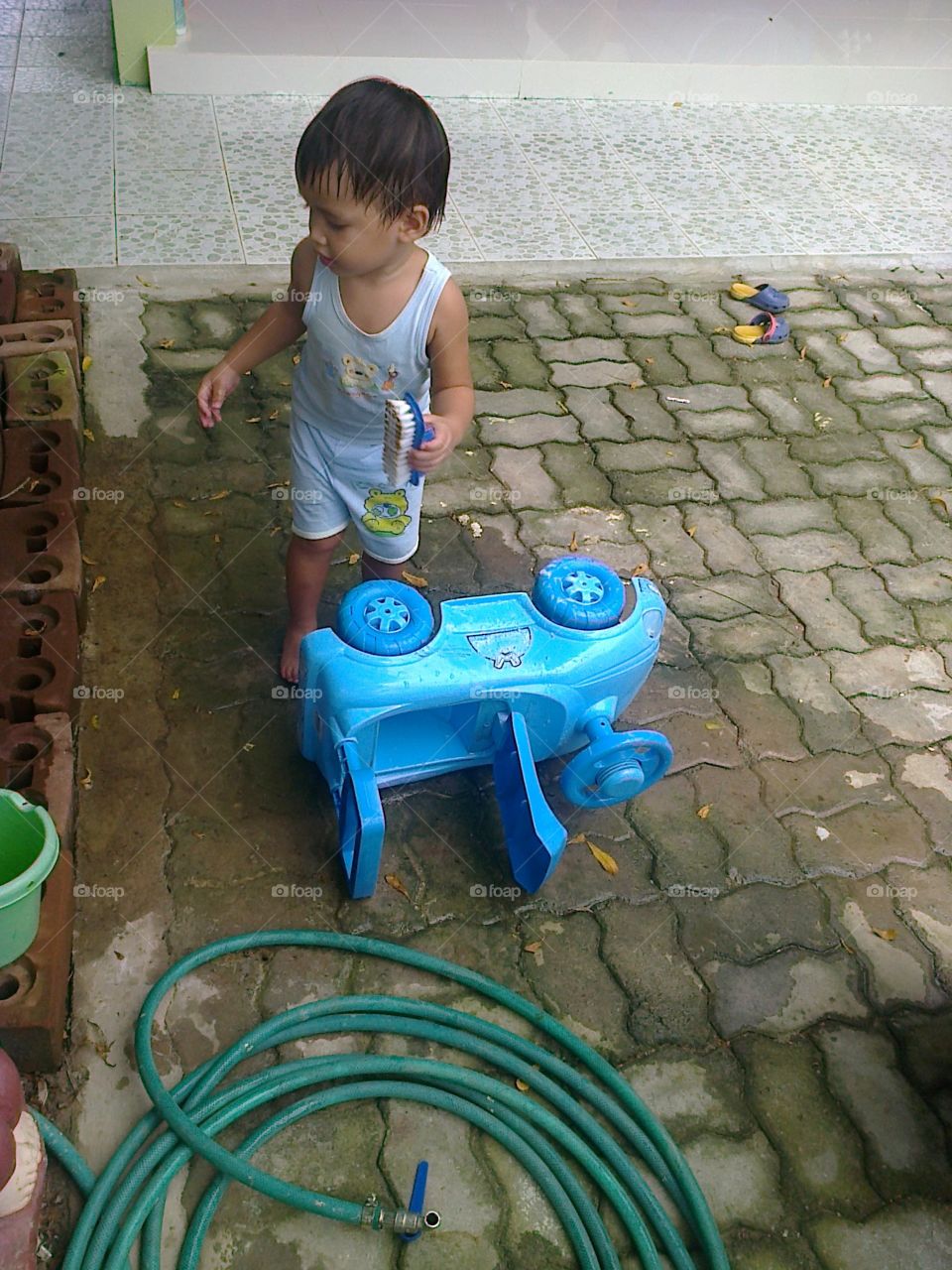 Car wash. boy cleaning his toy car