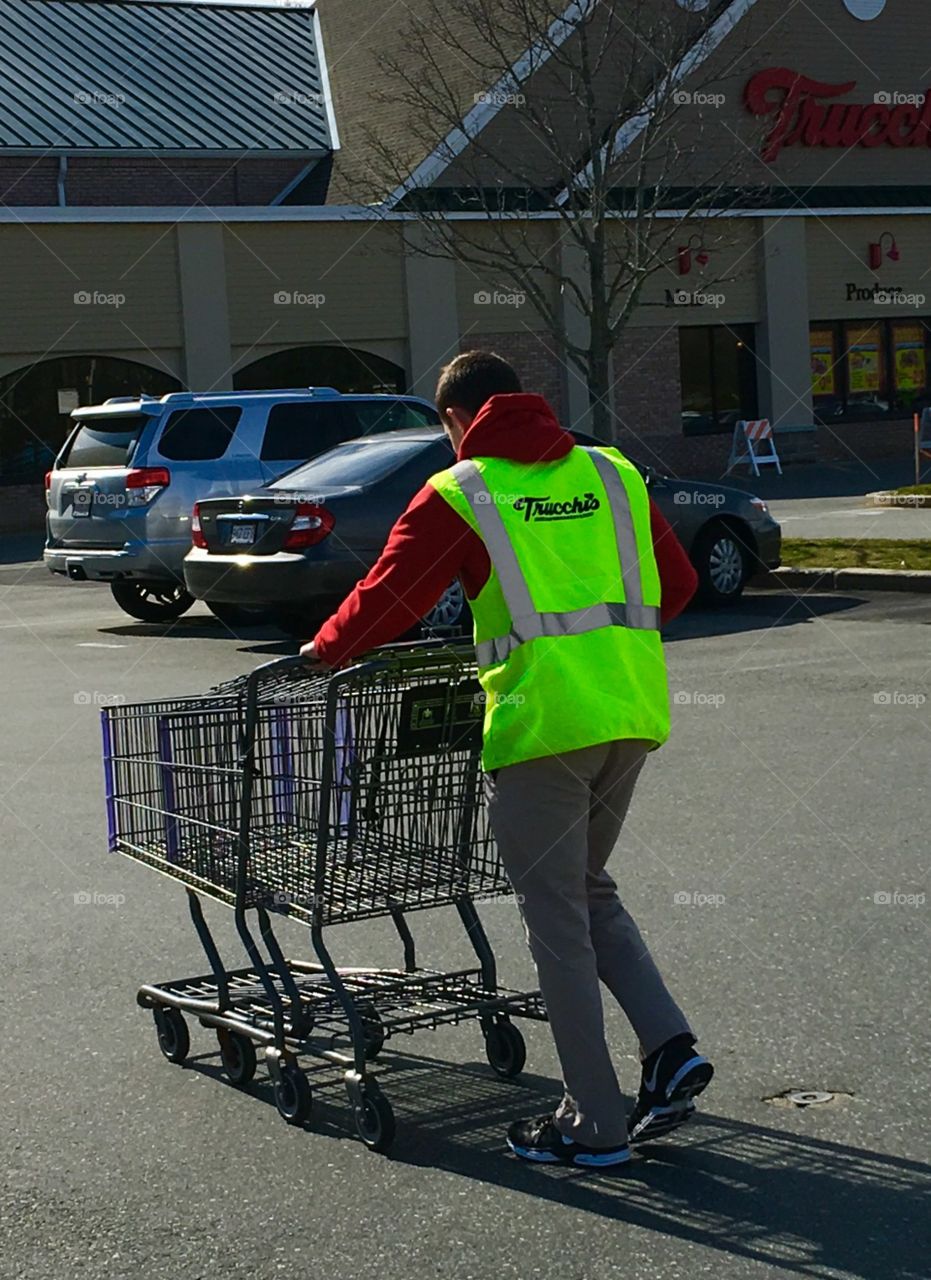 Grocery store worker bringing carriages back!
Our grocery store has workers that help to put food bags into the cars. This is great especially if it's bad weather. This man is bringing the carts back into the store after helping someone.