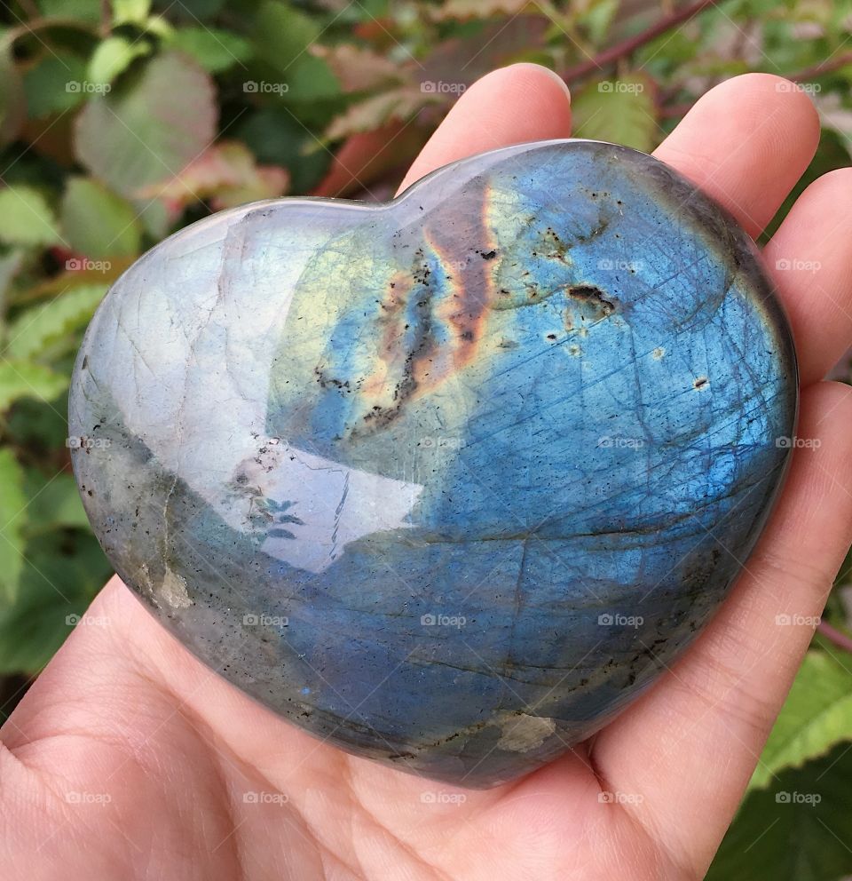 A heart-shaped labradorite mineral stone.