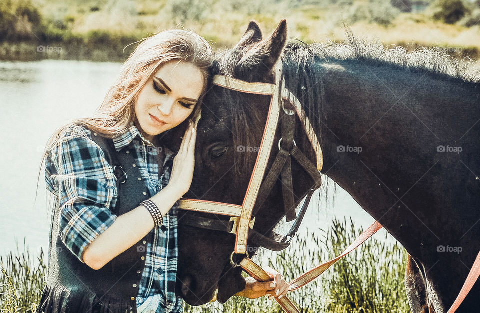 девушка в стиле вестерн нежно обнимает лошадь