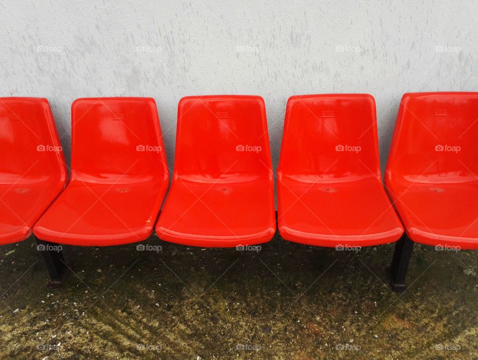 red stadium seats in he rain