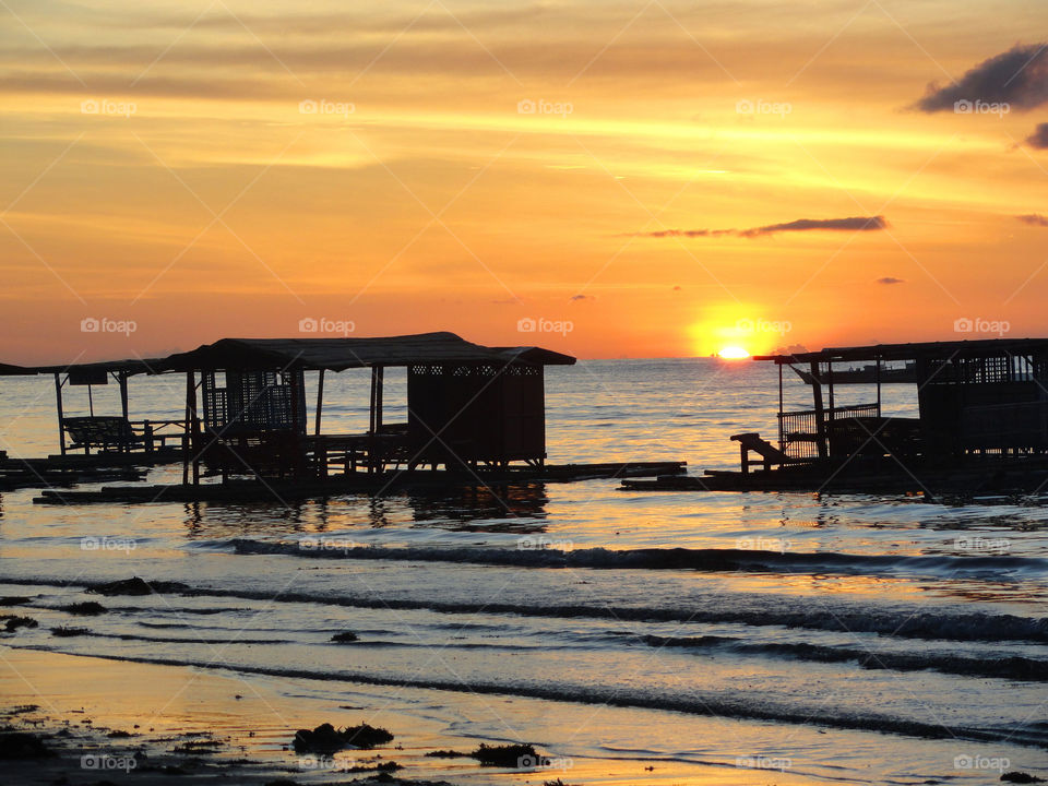 Scenic view of sea against orange sky