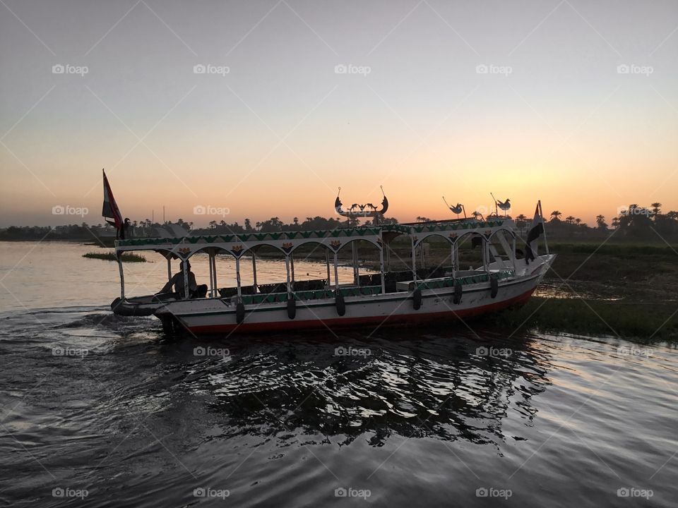Egyptian Felucca during sunset by the west bank of the river nile