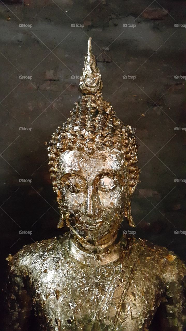 Antique buddha face in old temple of Ayutthaya Thailand
