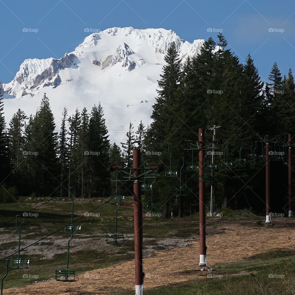 The magnificent Mt. Hood in Oregon’s Cascade Mountain Range covered in fresh springtime snow on a beautiful sunny day. 