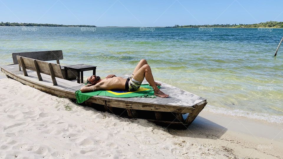Man relaxing on boat near lake