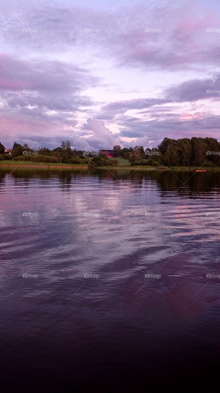 purple coloured sunset on  sky and lake