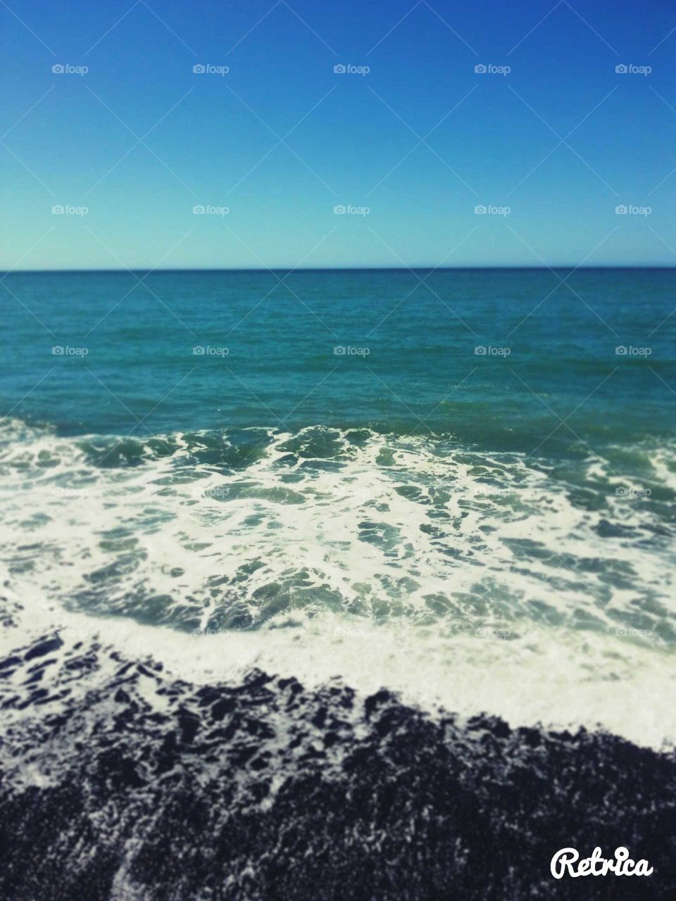 "Calm" are the waves on our stony beach. Hawkes Bay on a summer's day NZ
