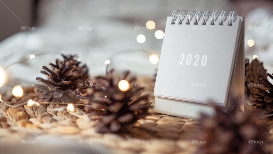 2020 new year grey calendar on rustic server with pines and lights