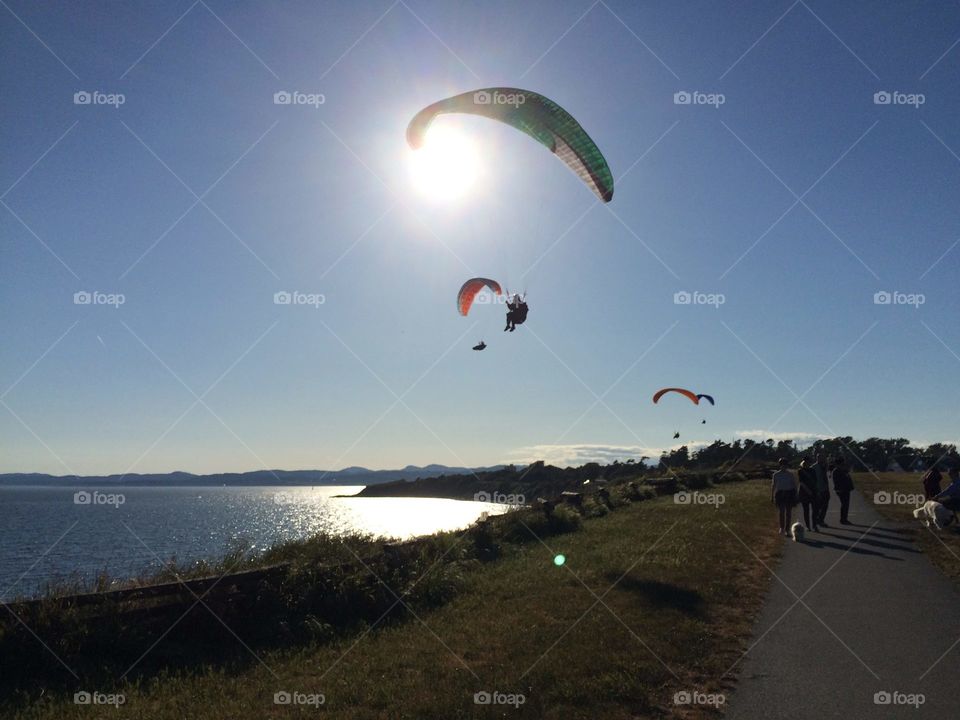 Paraglider illuminated by sun-rays 