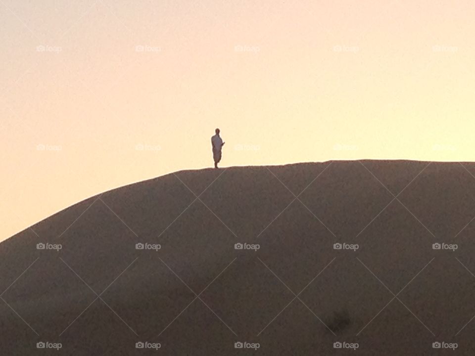 Lonely Traveler. Man on top of dune in Rub' al Khali, Abu Dhabi. 
