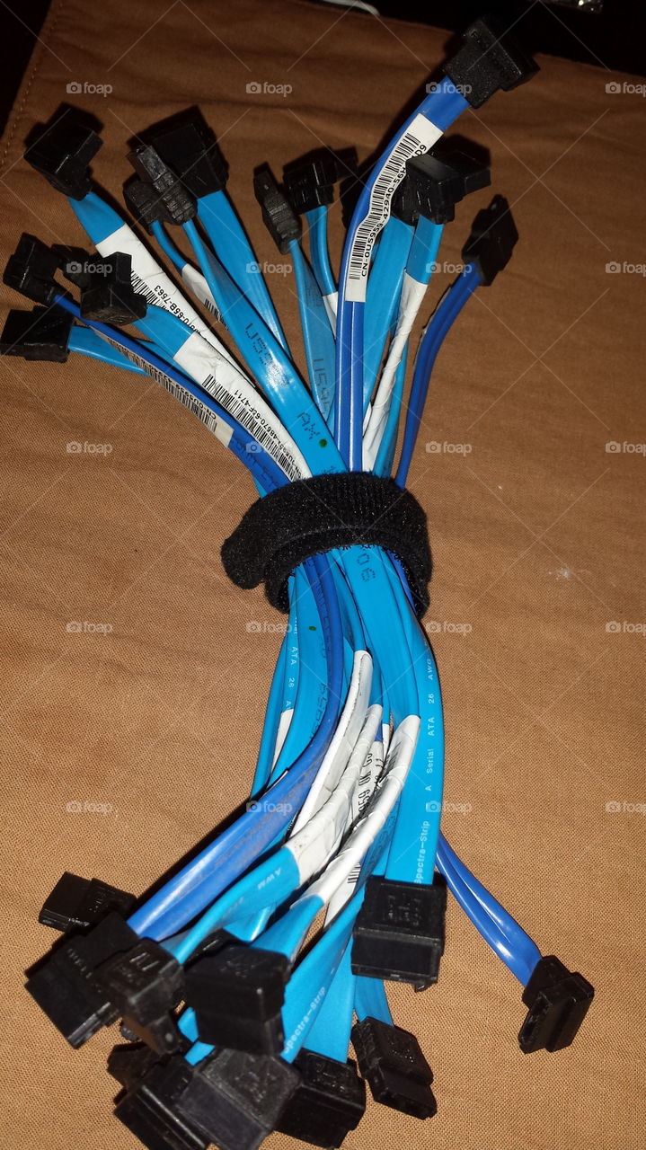 Bunch of SATA cables for computers wrapped around a velcro strap.