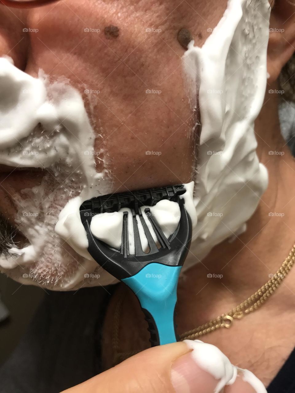 shaving with face foam close up