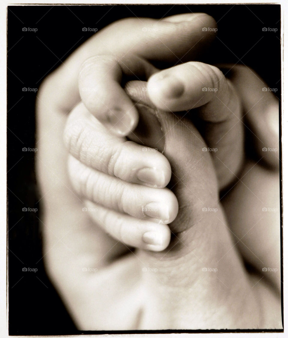 hands black and white newborn by jbrinkler