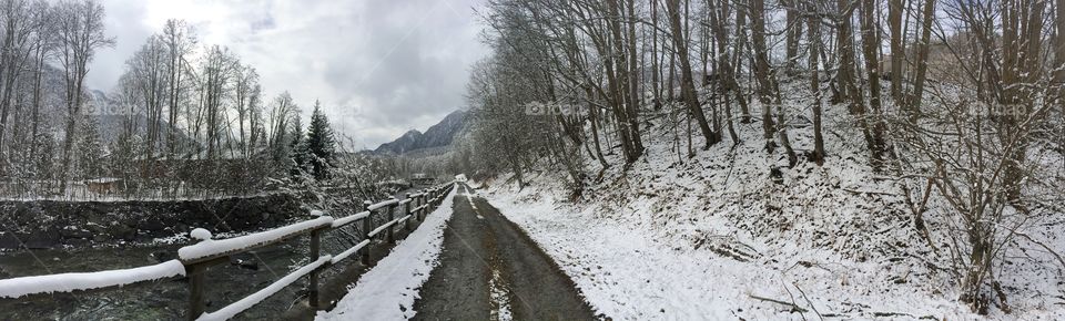 Mountain trail alone the river in winter time 