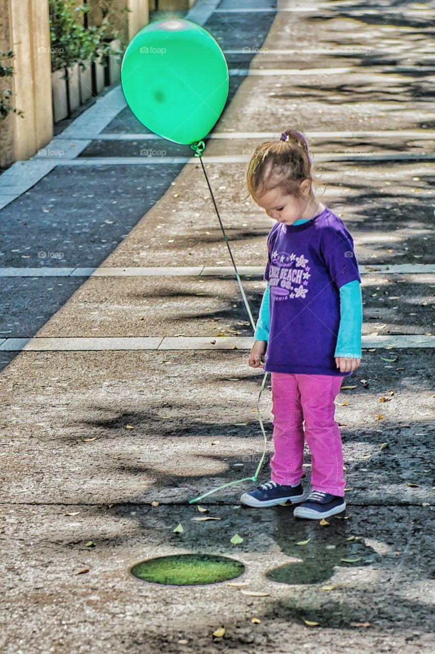 Cute girl holding balloon in hand