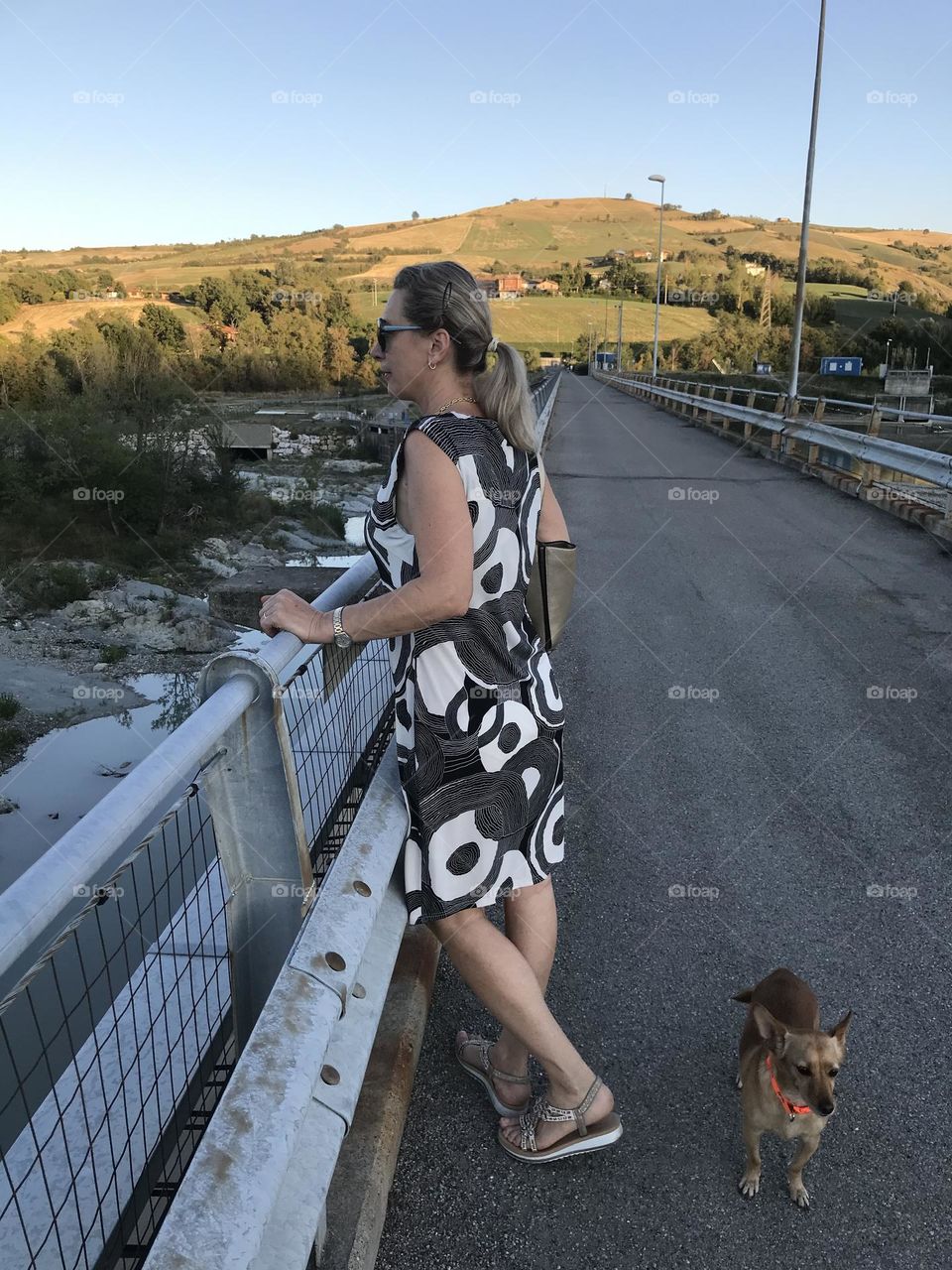 woman poses on the bridge, panorama