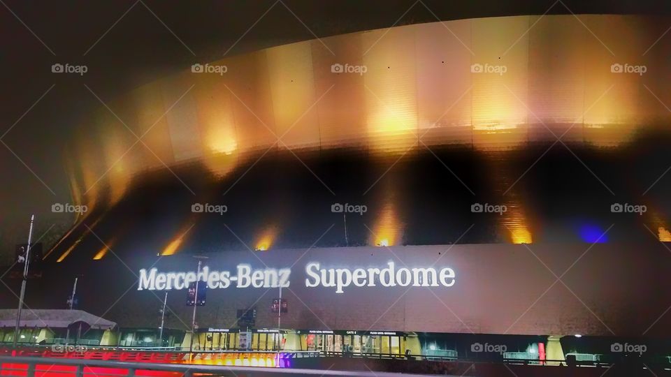 Night view of the Mercedes-Benz Superdome - from a rainy and foggy evening. New Orleans, Louisiana, USA.