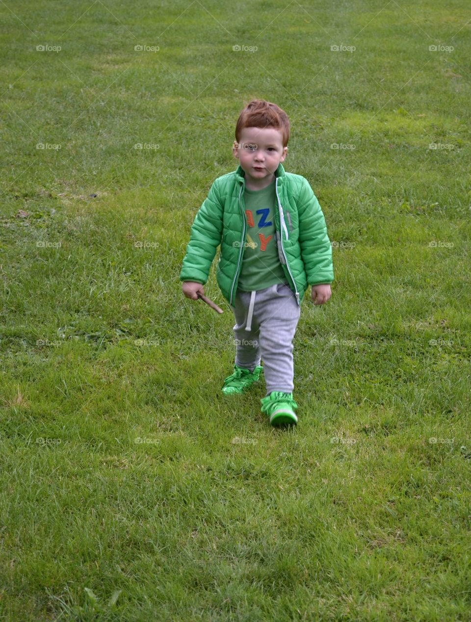 Cute boy walking on grass