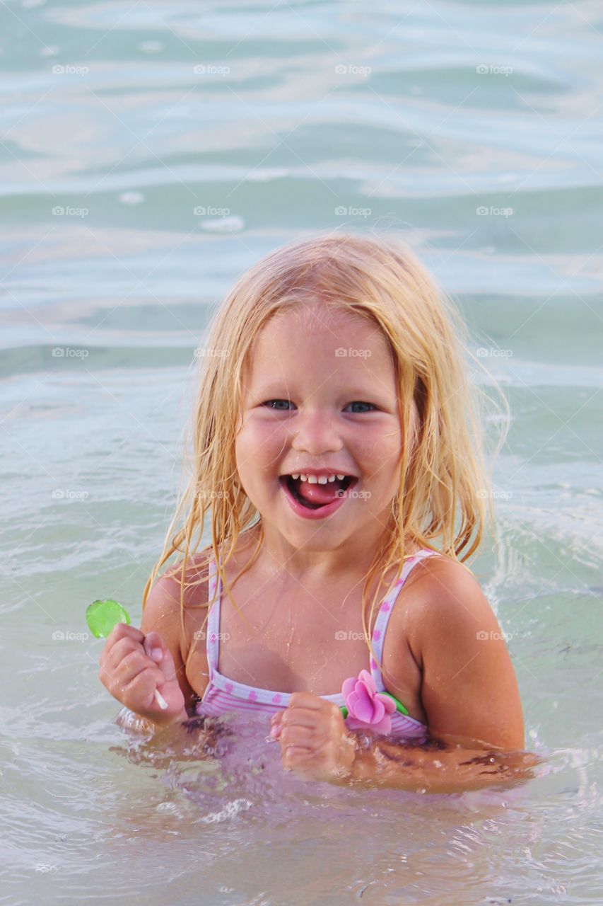 Little girl playing in the ocean