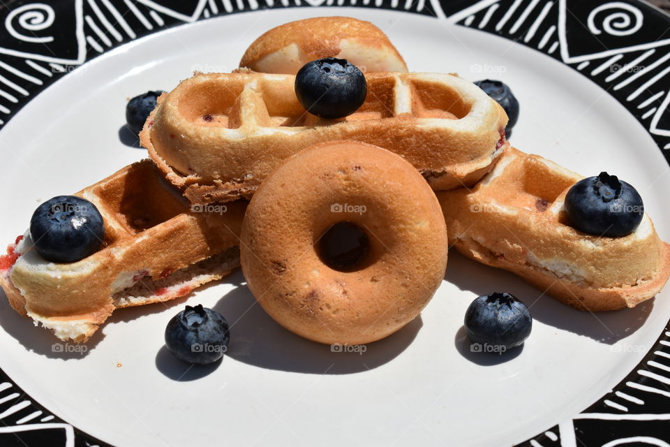 strawberry doughnuts and waffles with blueberries.