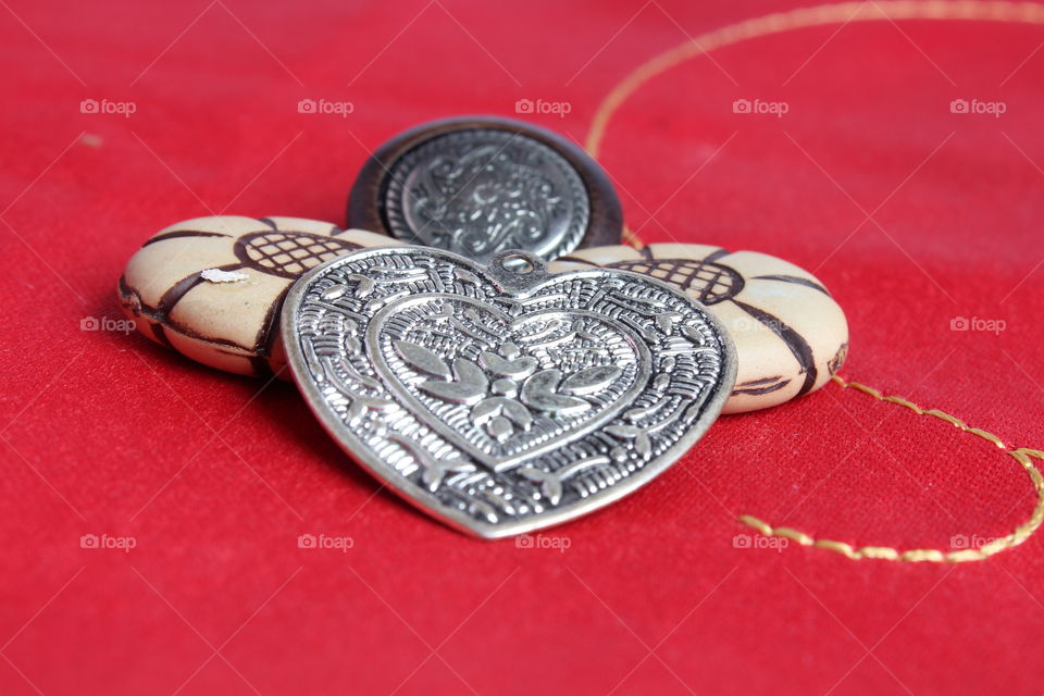 Macro shot of Valentine's day decorations metal heart and buttons