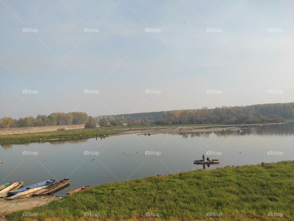 Kovin Serbia river Danube canal with fisherman on boat in autumn