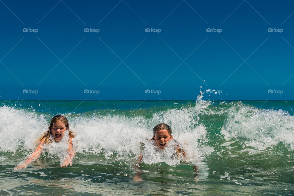 girls are enjoying to ride on the waves and have fun