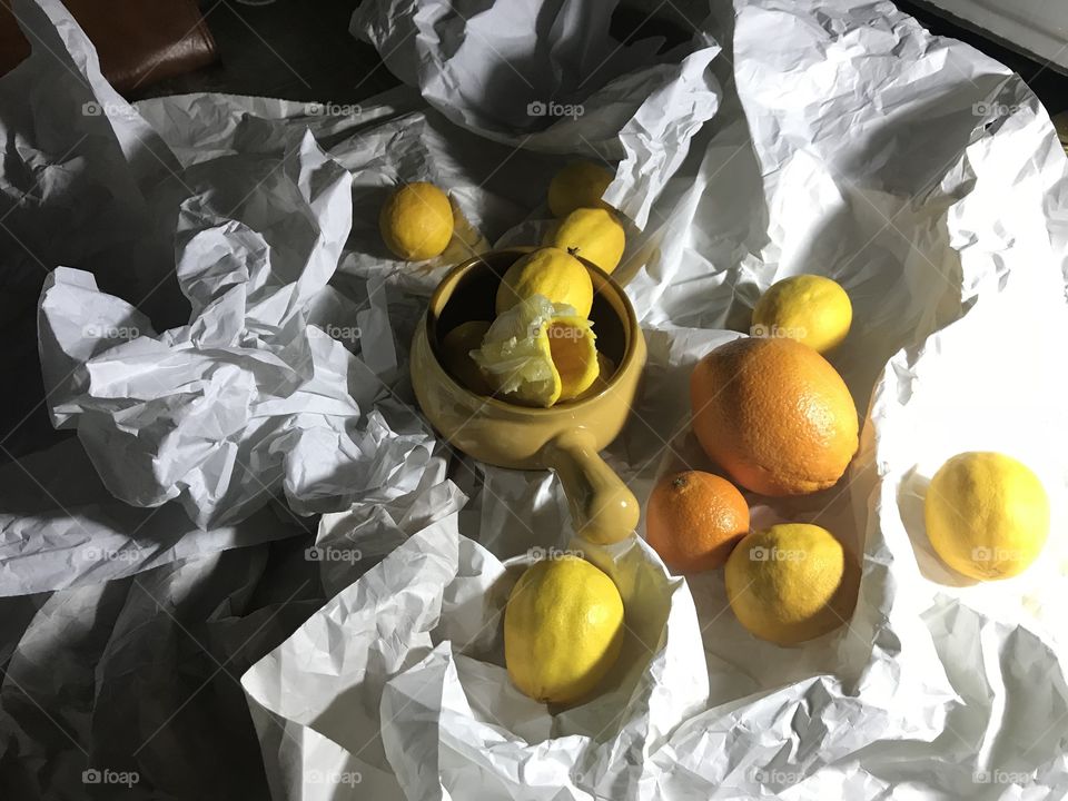 Lemons and oranges on a crumpled paper 