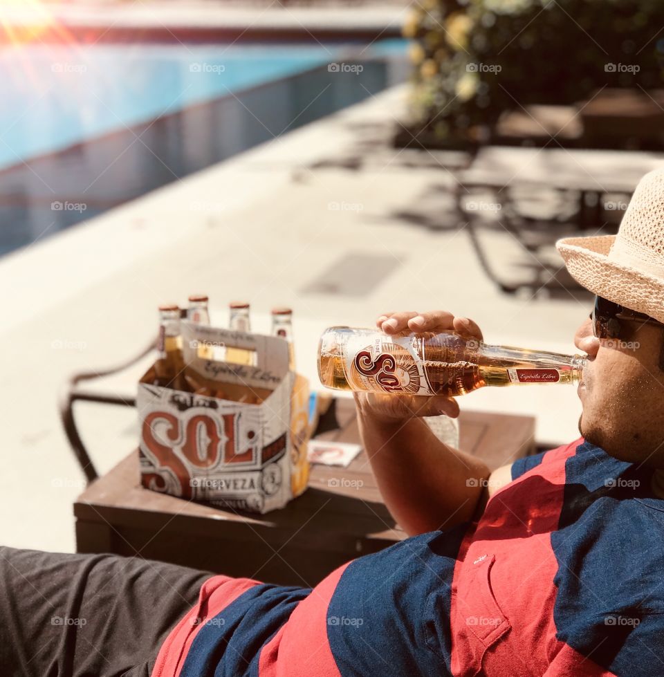 Enjoying with sol beer under sun