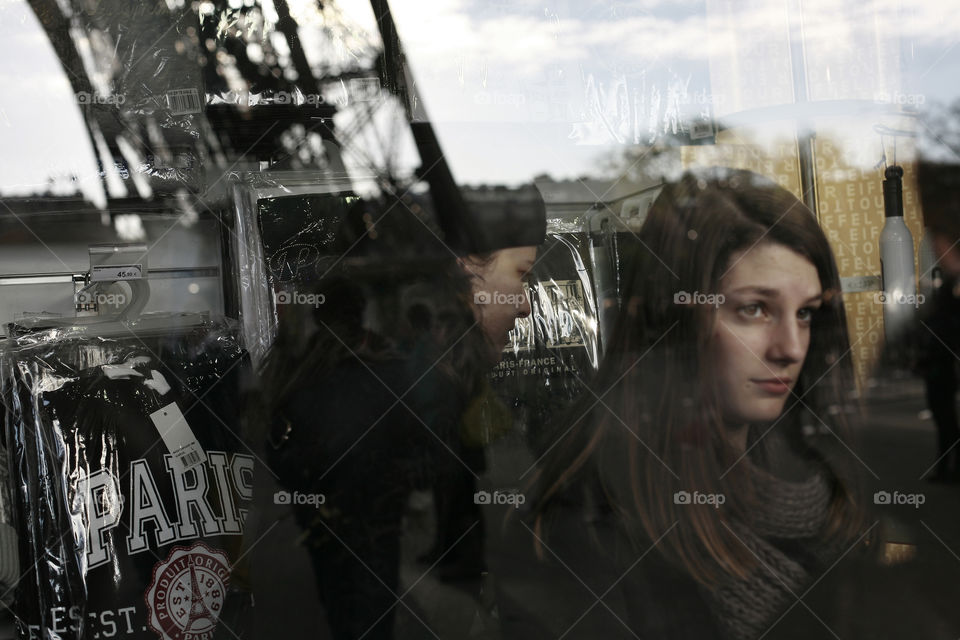 people in a Paris gift shop. two girls in a Eiffel towet gift shop