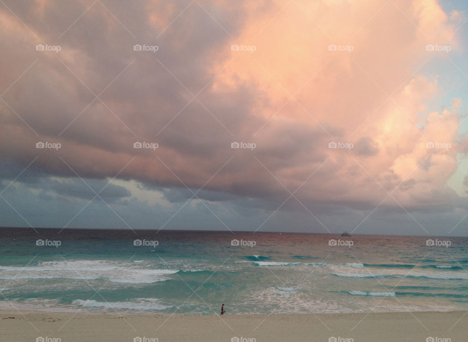 Storm clouds over sea during sunset