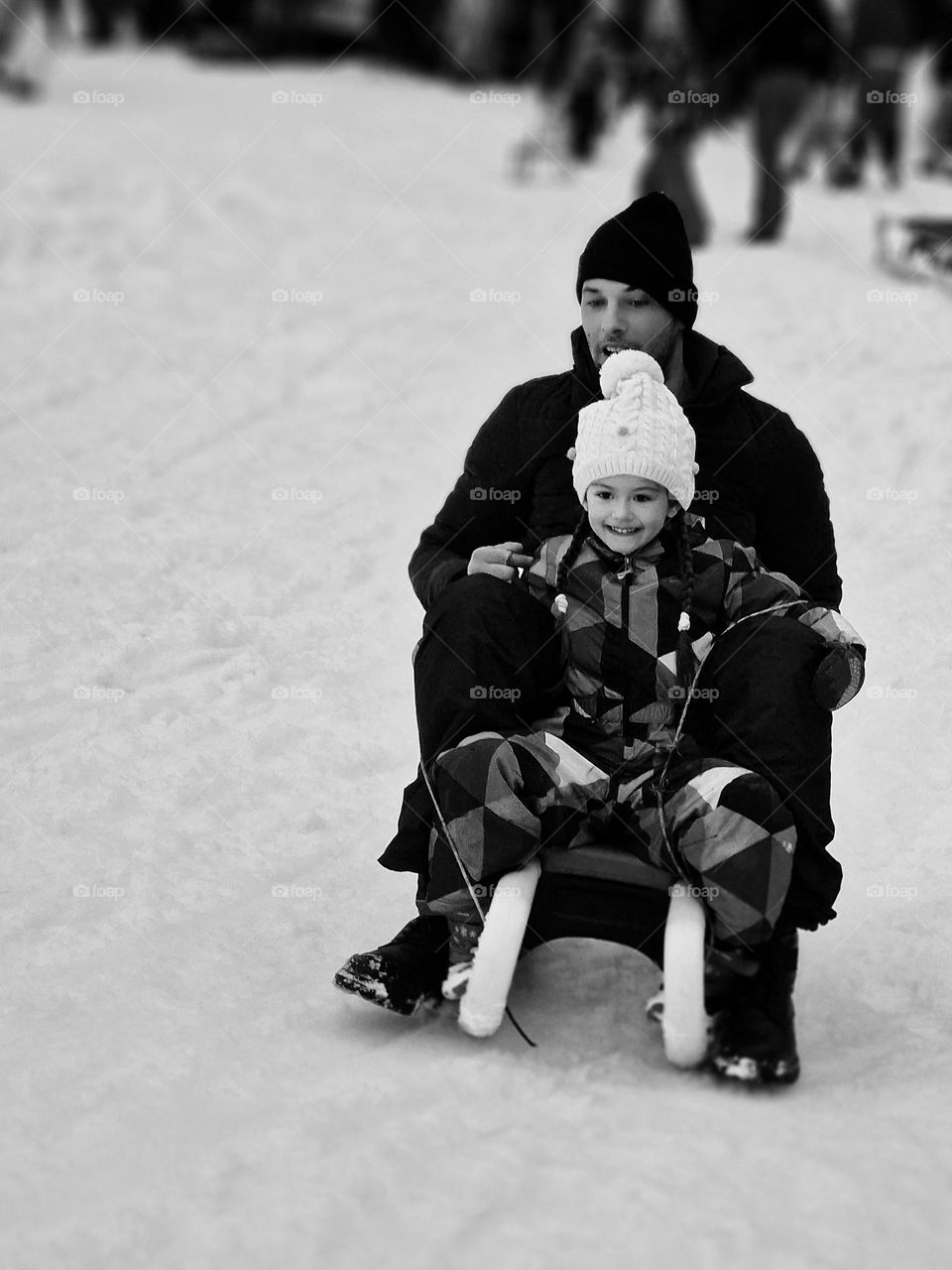 moment of joy on the sled in black and white