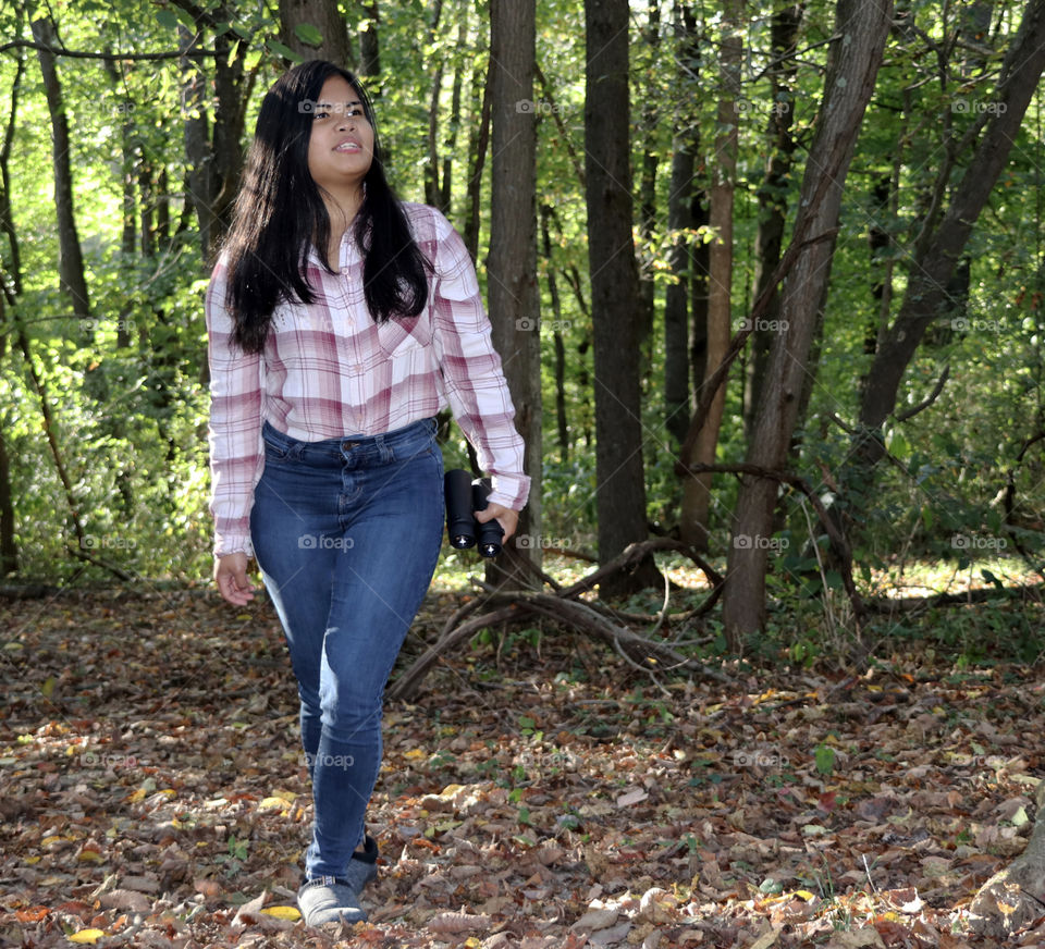 Girl walking through the woods 