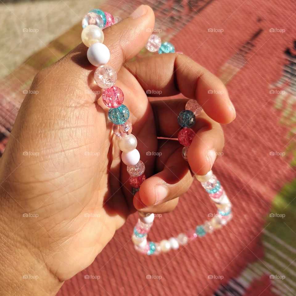 reflection of sunrays on beads and shadow