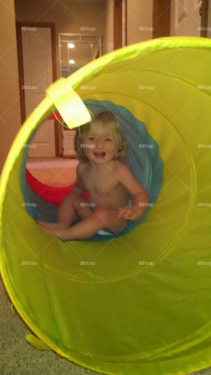 Baby in play tunnel
