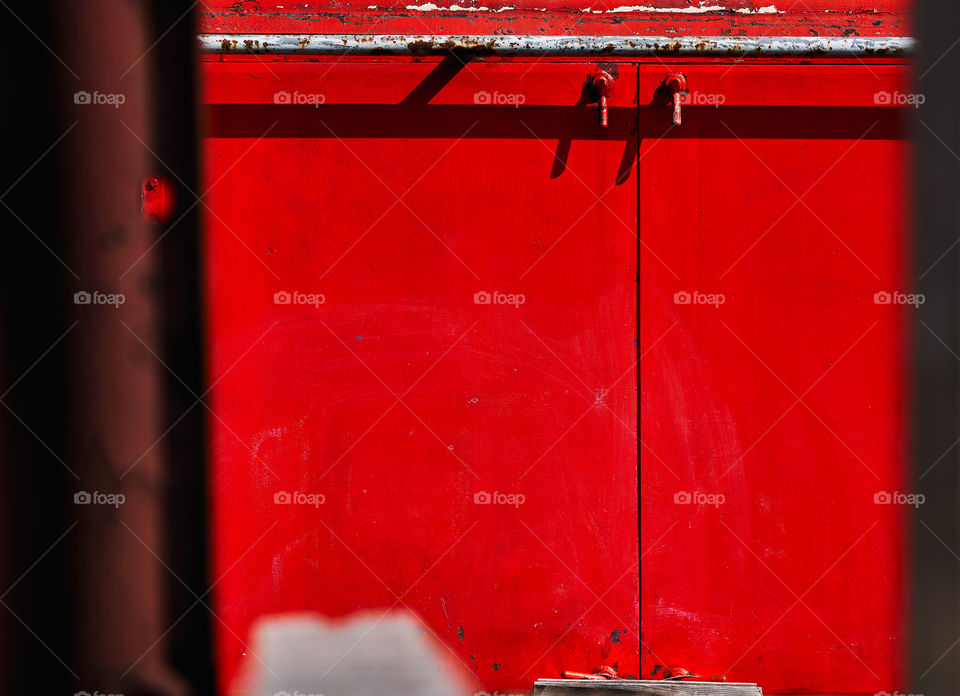 Red abstract lines and structures on the side of an old locomotive