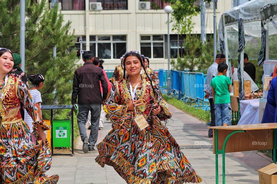 independence day in Uzbekistan. On the day of the holiday, people honor traditions by dressing up in national costumes and organizing fairs with performances.  in the photo of a girl in national festive  dresses.