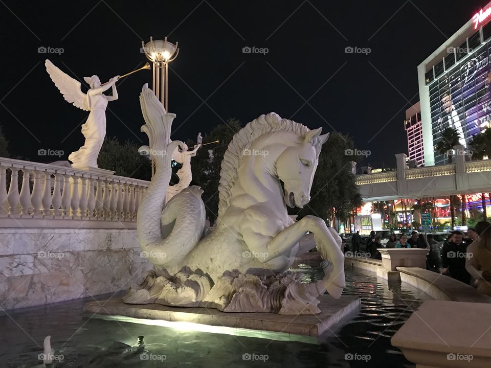 Light shining on the beautiful statue on the Strip of Las Vegas, Nevada around midnight. 