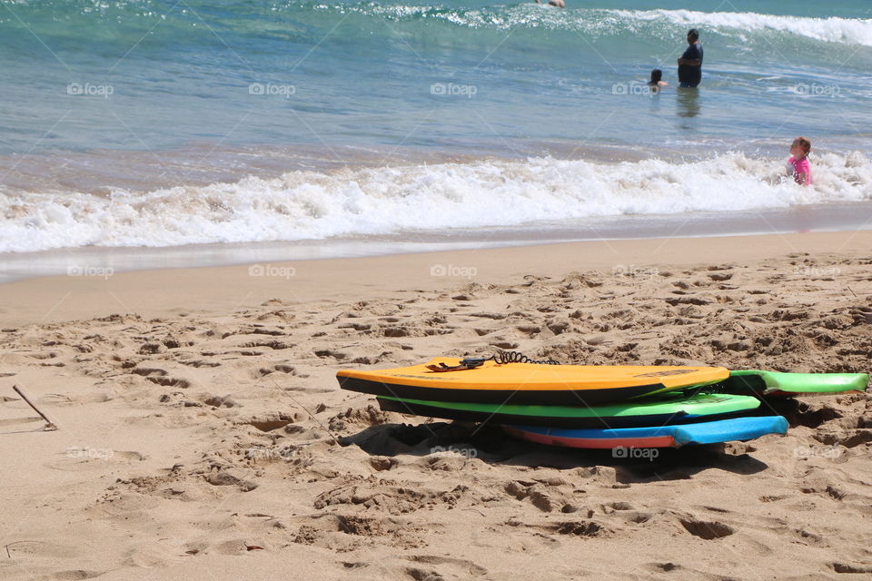 Boards with different colours arranged on sand