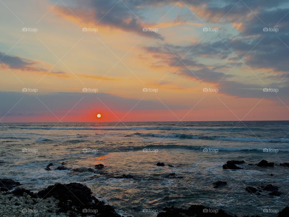 Sunsational Evening. Orange sun setting on Pacific Ocean, Kona, Hawaii, USA.