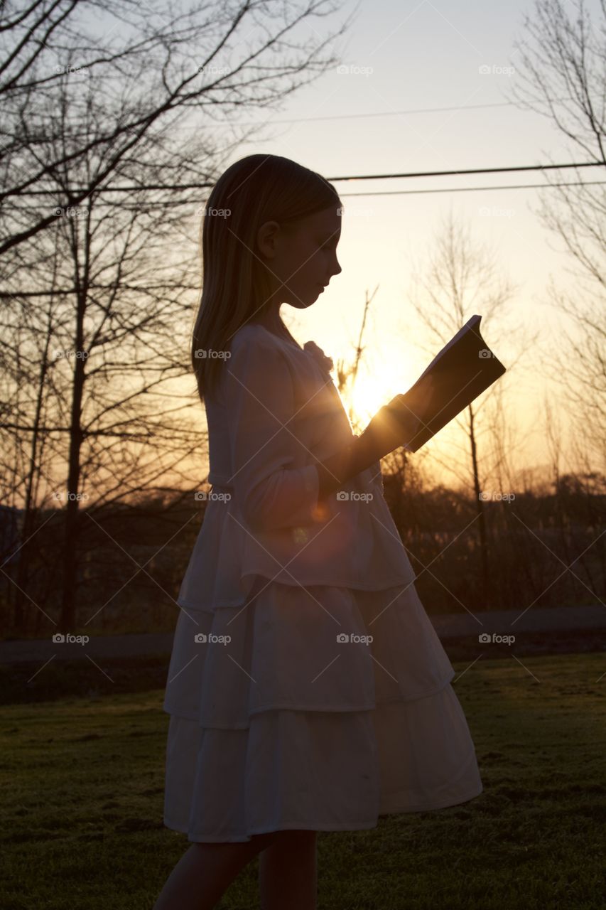 Girl reading in sunset