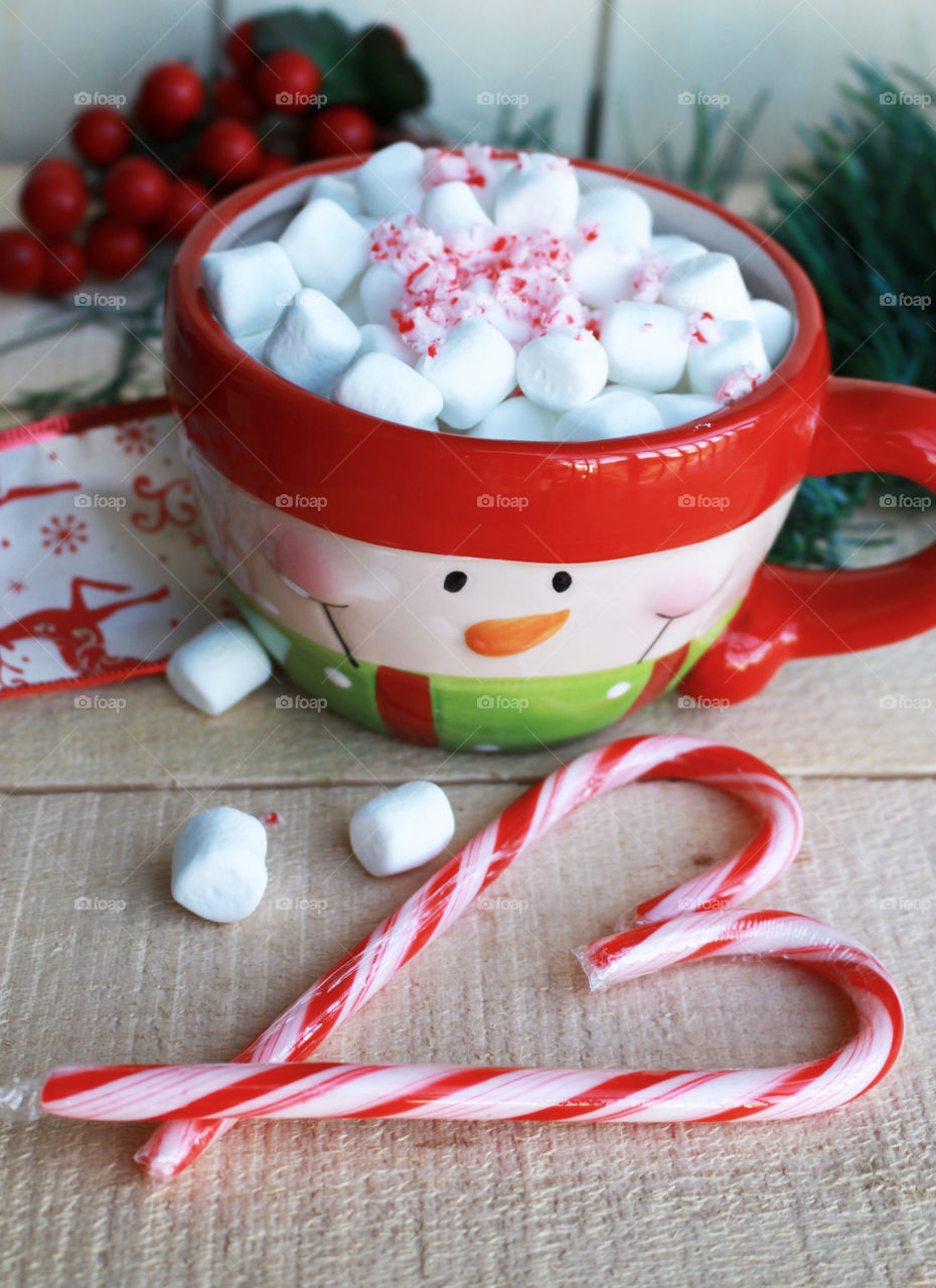 Tasty marshmallow in cup with candy cane