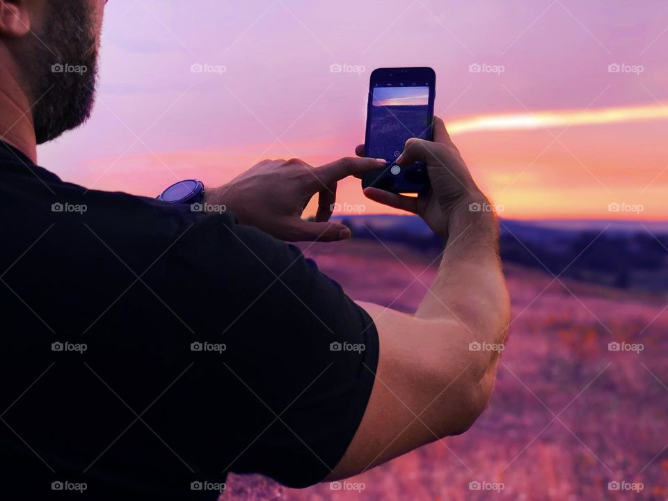 Taking a photo of purple sunset 