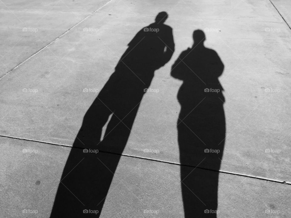￼
Shadows of man and woman walking 