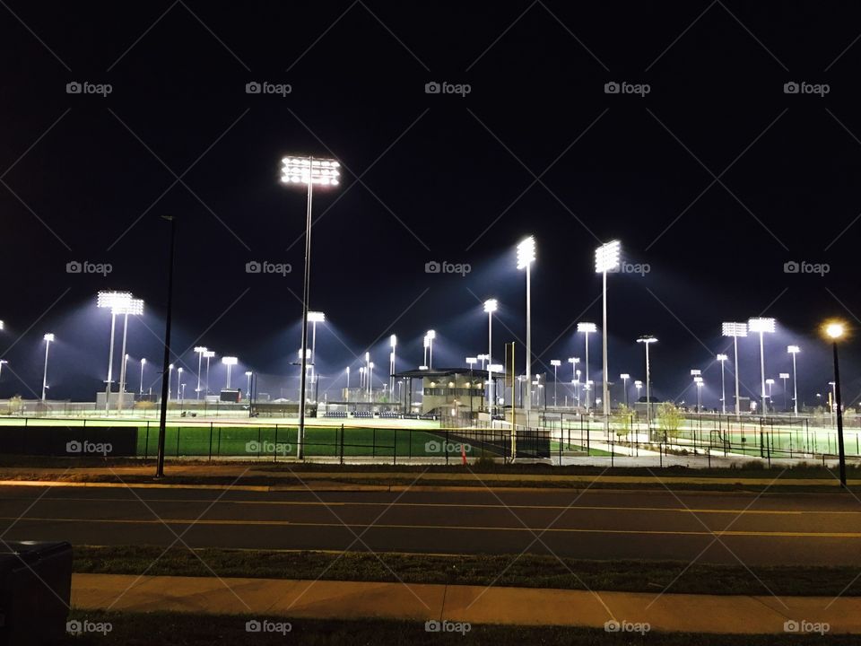 Giant baseball facility at night.