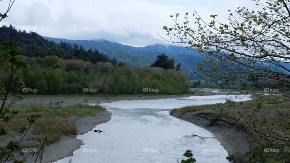 River flowing through forest and holls.