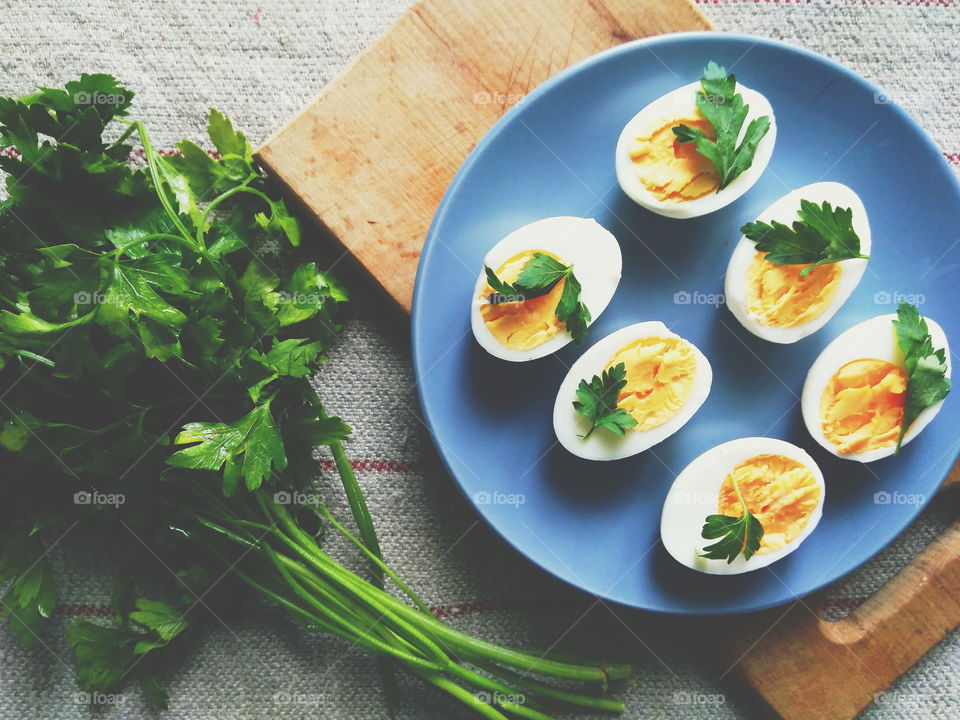 cut boiled eggs decorated with parsley