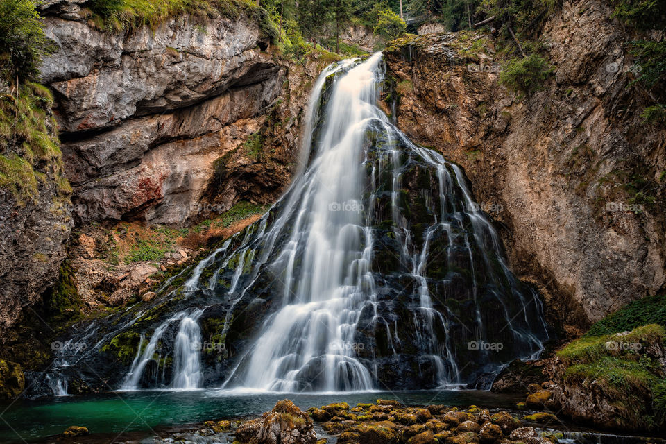 Beautiful view of famous Gollinger Wasserfall with mosy rocks and green trees, Golling, Salzburger Land, Austria
