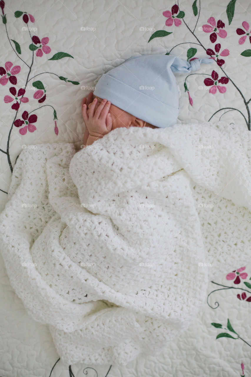 Newborn baby boy sleeping in blanket 